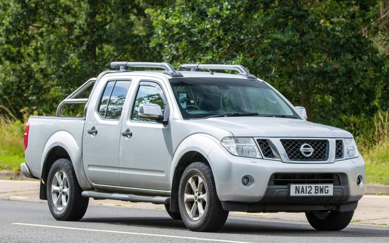 Nissan Navara driving on an English road, similar to Frontier pickup model