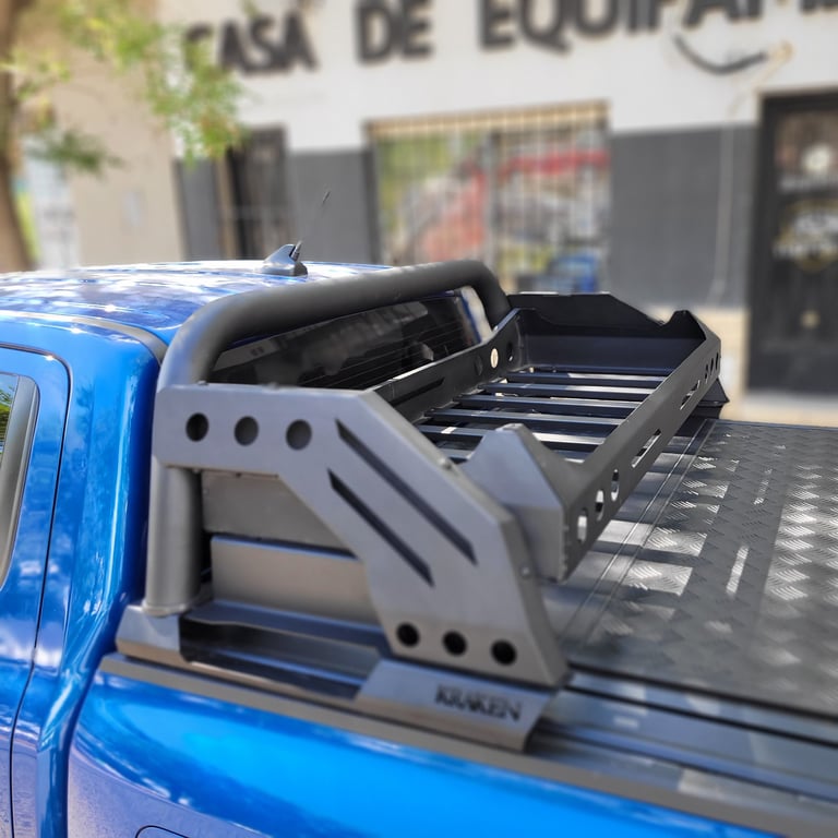 Blue pickup truck with an open tonneau cover and bed rack accessory mounted on the cargo bed