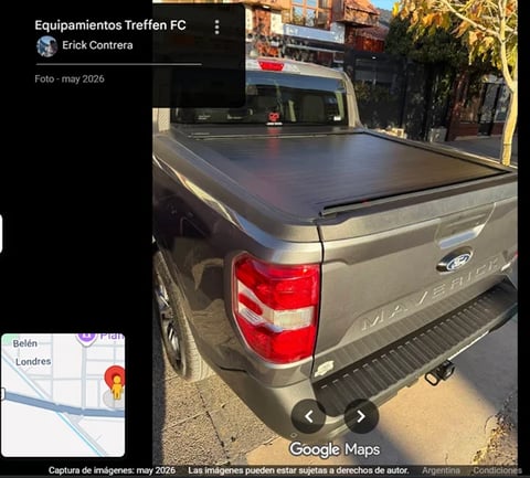 Gray pickup truck with tonneau cover bed and red taillights parked on a street in Buenos Aires