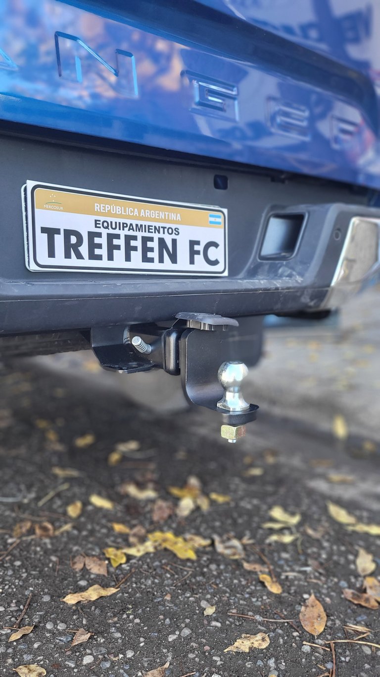 Argentine license plate reading TREFFEN FC on dark vehicle with trailer hitch visible