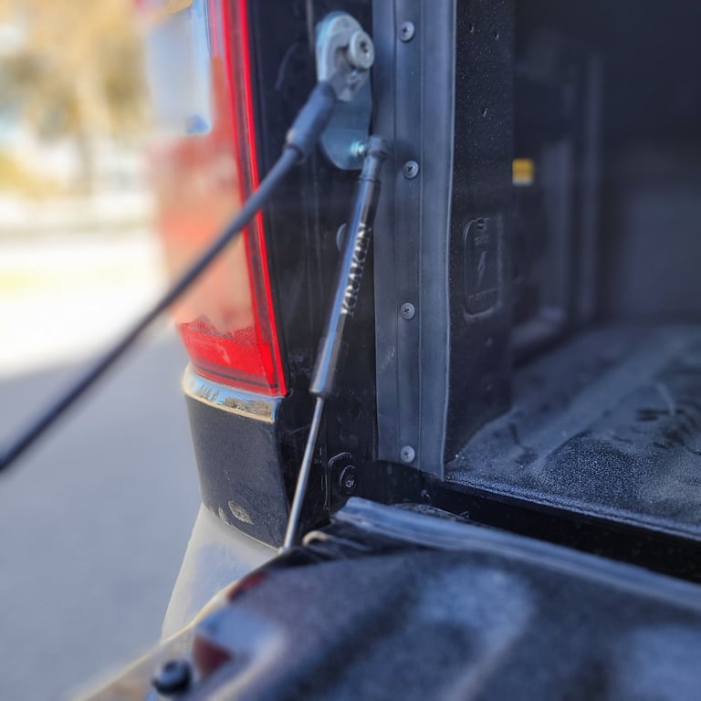 Close-up of a vehicle hitch with a metal towing ball connector and red taillight visible