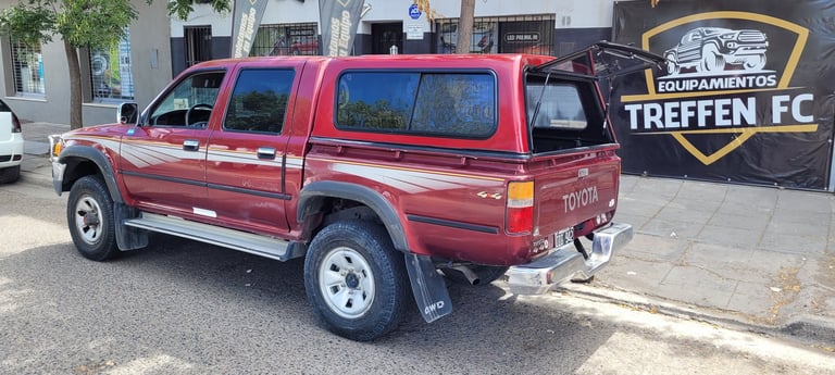 Red pickup truck parked next to Treffen FC sports facility sign