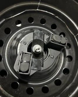 Close-up of car brake system with disc rotors and calipers on steel wheel