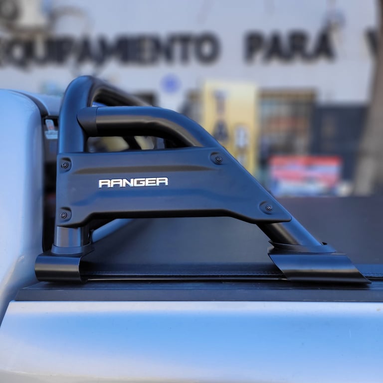 Blue Ranger roof rack mounted on pickup truck bed with urban background
