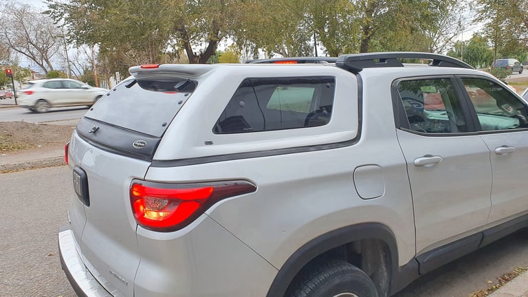 Silver SUV parked in residential area with trees in background on overcast day