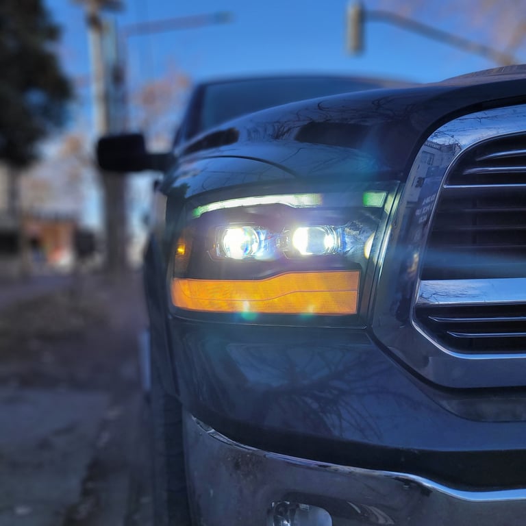 Close-up of a trucks headlight with LED lights on at dusk